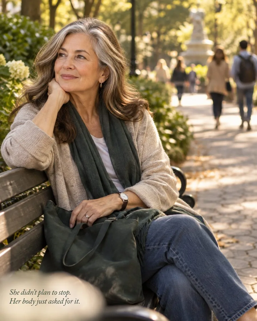 Woman resting on a park bench — she didn't plan to stop, her body just asked for it